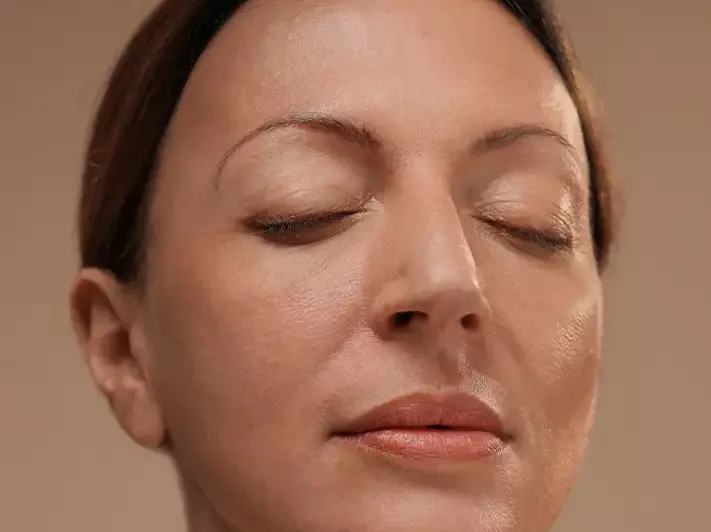 A woman with a super-fresh skin, looking calm and peaceful