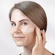 Woman applying Cerabuild Face and Neck Cream on her face
