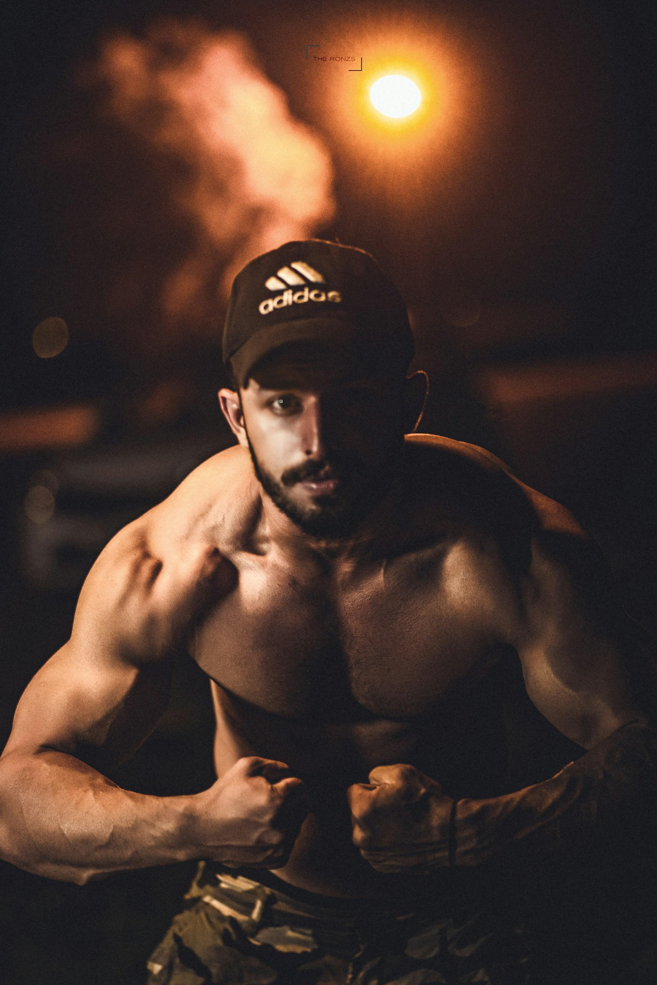man flexing his chest muscles