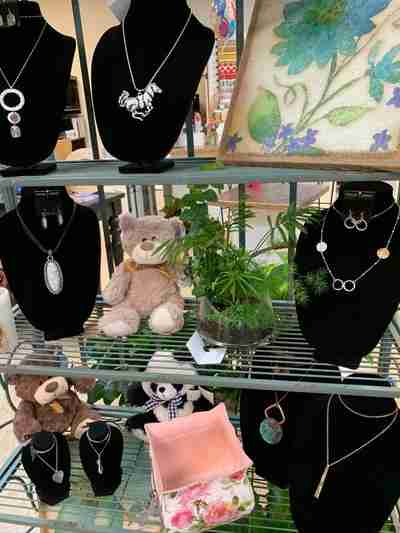 Shelves filled with plush animals, jewelry, and plants