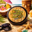 A tin of dirty dangles tiki deke limited edition tropical stick wax on a beach with tiki drinks and sea shells/\.