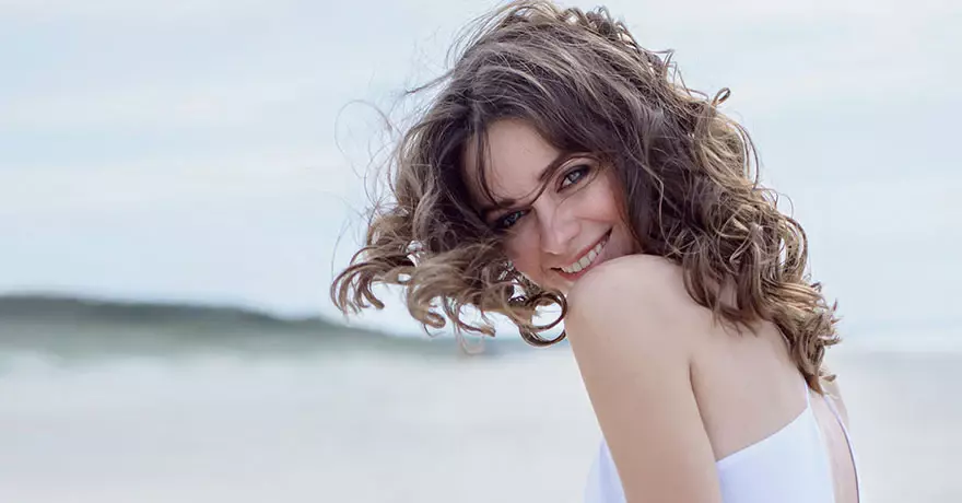 woman on beach with blowing hair