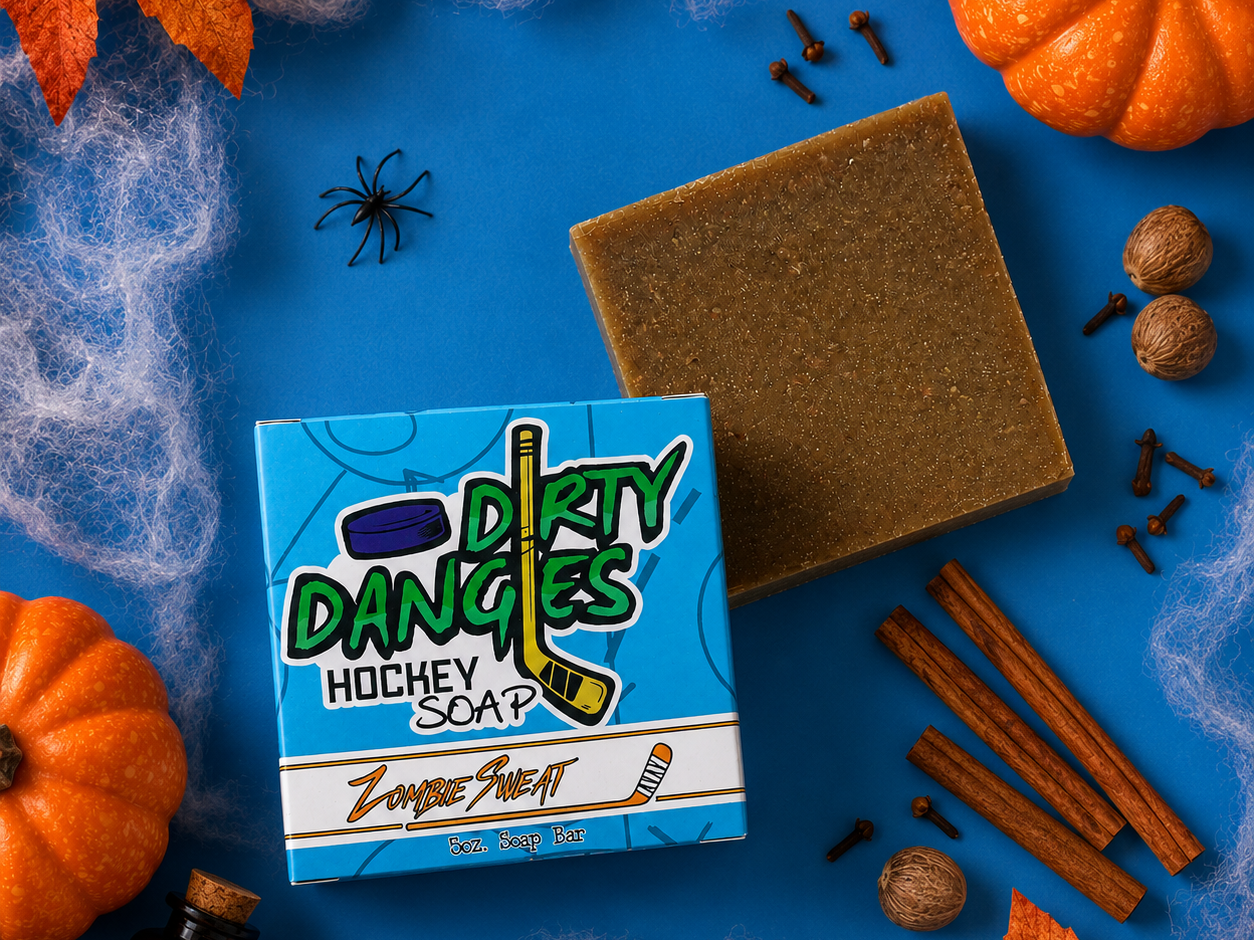 zombie sweat pumpkin spice scented hockey soap bar on a blue background with spices, spiderwebs and fall decor