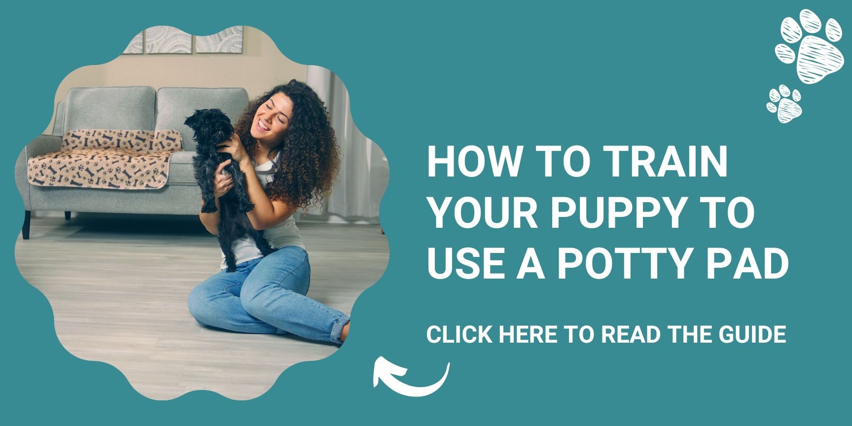 Woman hugging dog sitting on floor in front of sofa with a potty pad