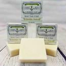 picture of 3 yellow bars of shart wash handmade soap bars, Hawaiian Pooau scent. on a wood background