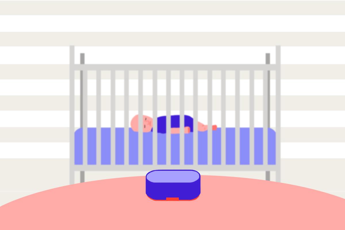 A baby sleeping in a crib with a white noise machine placed far away from the crib.