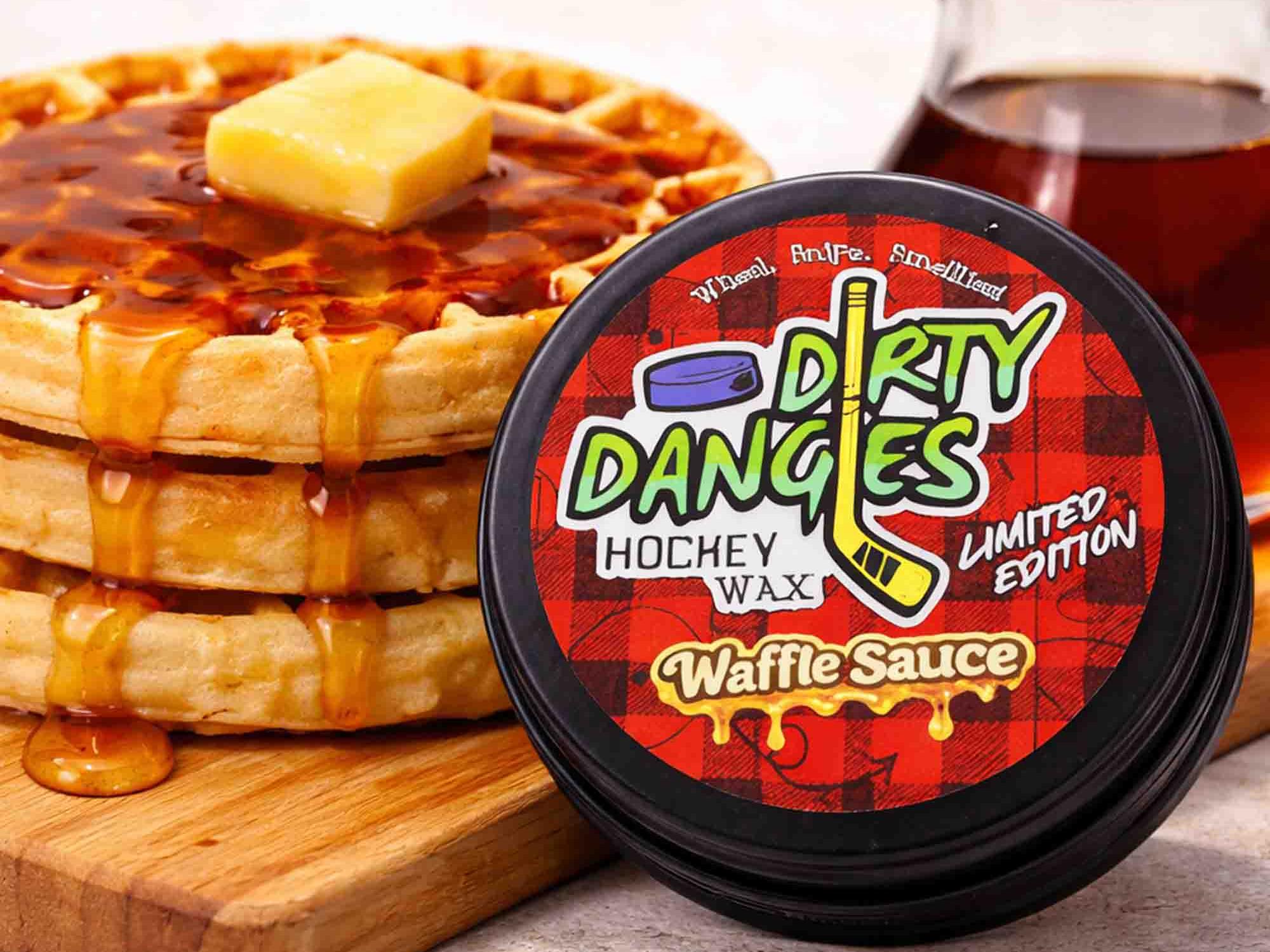Container of 'Dirty Dangles' hockey wax Waffle Sauce Scent with a stack of waffles and syrup on a wooden board.