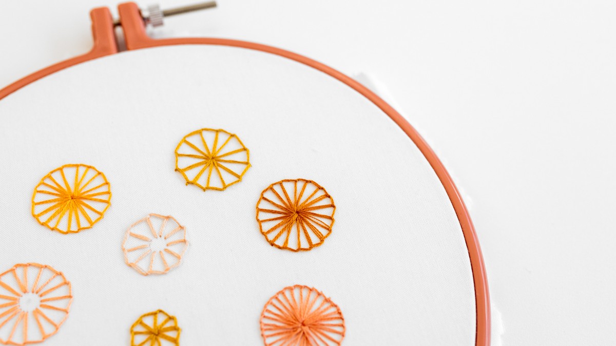 This image shows buttonhole wheels embroidered on the embroidery fabric.