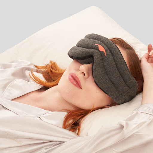 A girl lying down wearing a weighted sleep mask from Manta Sleep.