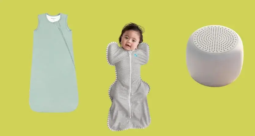 A baby peacefully sleeping in a BubblePanda Rayon Sleep Sack, with a Babelio White Noise Sound Machine and a pillow nearby.