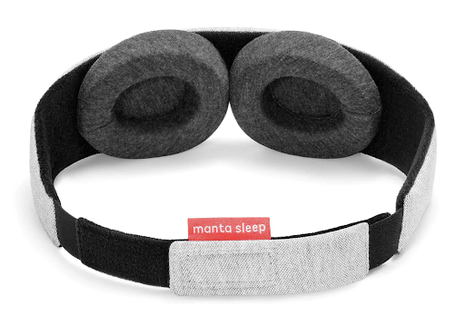The interior of a gray adjustable sleep mask with eye cups and a micro hook and loop closure.