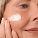 Women applying Blavana ultra-rich Youth-Boost Face Pommade on face