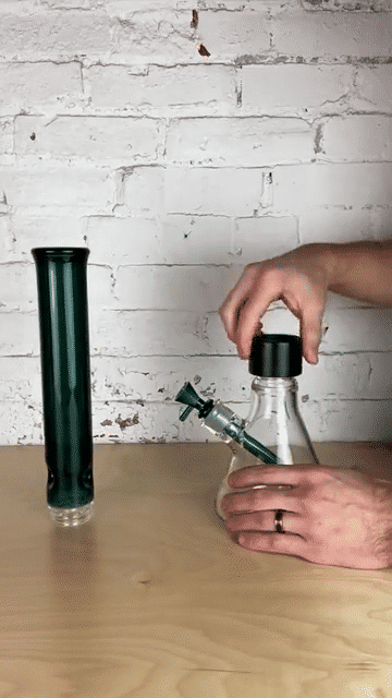 A GIF demonstration of a user assembling a Prism modular water pipe. The video shows a black Halo Connector being threaded onto a glass base, followed by a Tall Teal Standard Mouthpiece being securely twisted onto the connector, illustrating the tool-free, airtight assembly process.