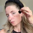 woman applying hyah serum to her face