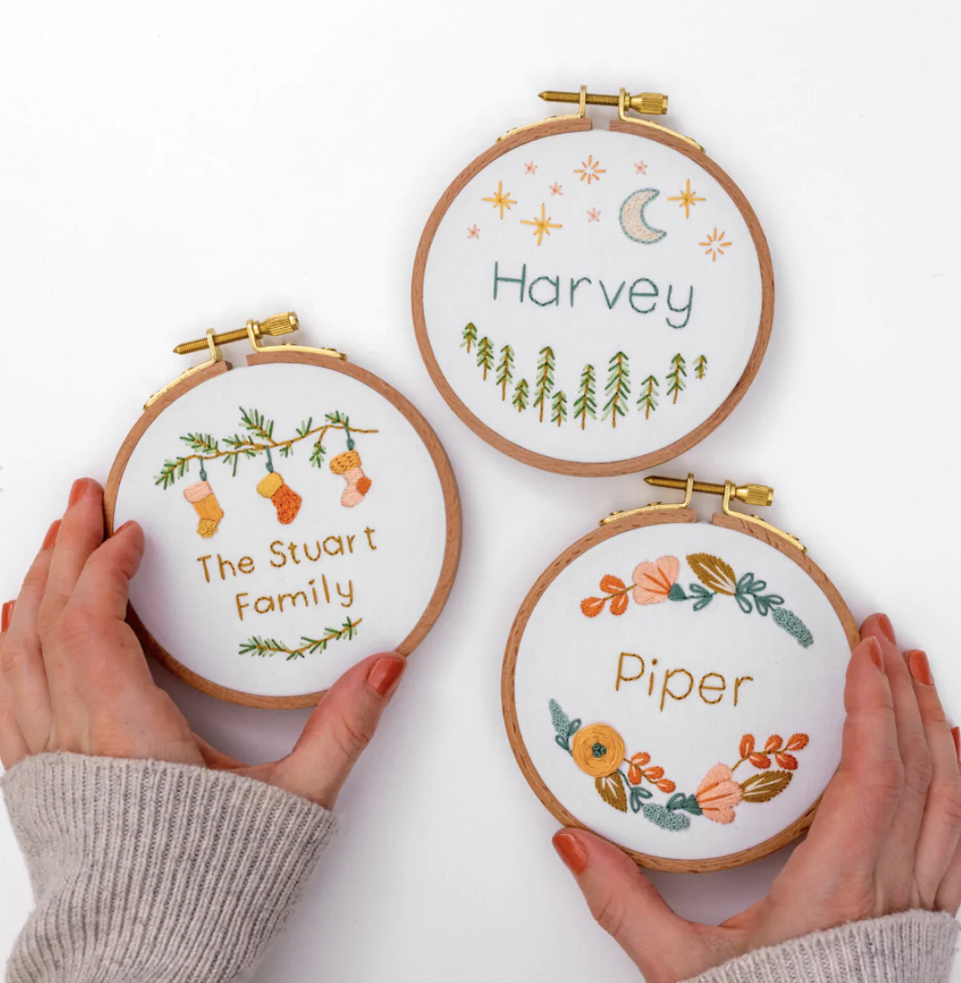 Hands hold the personalised bauble pattern, available from the Clever Poppy Shop.