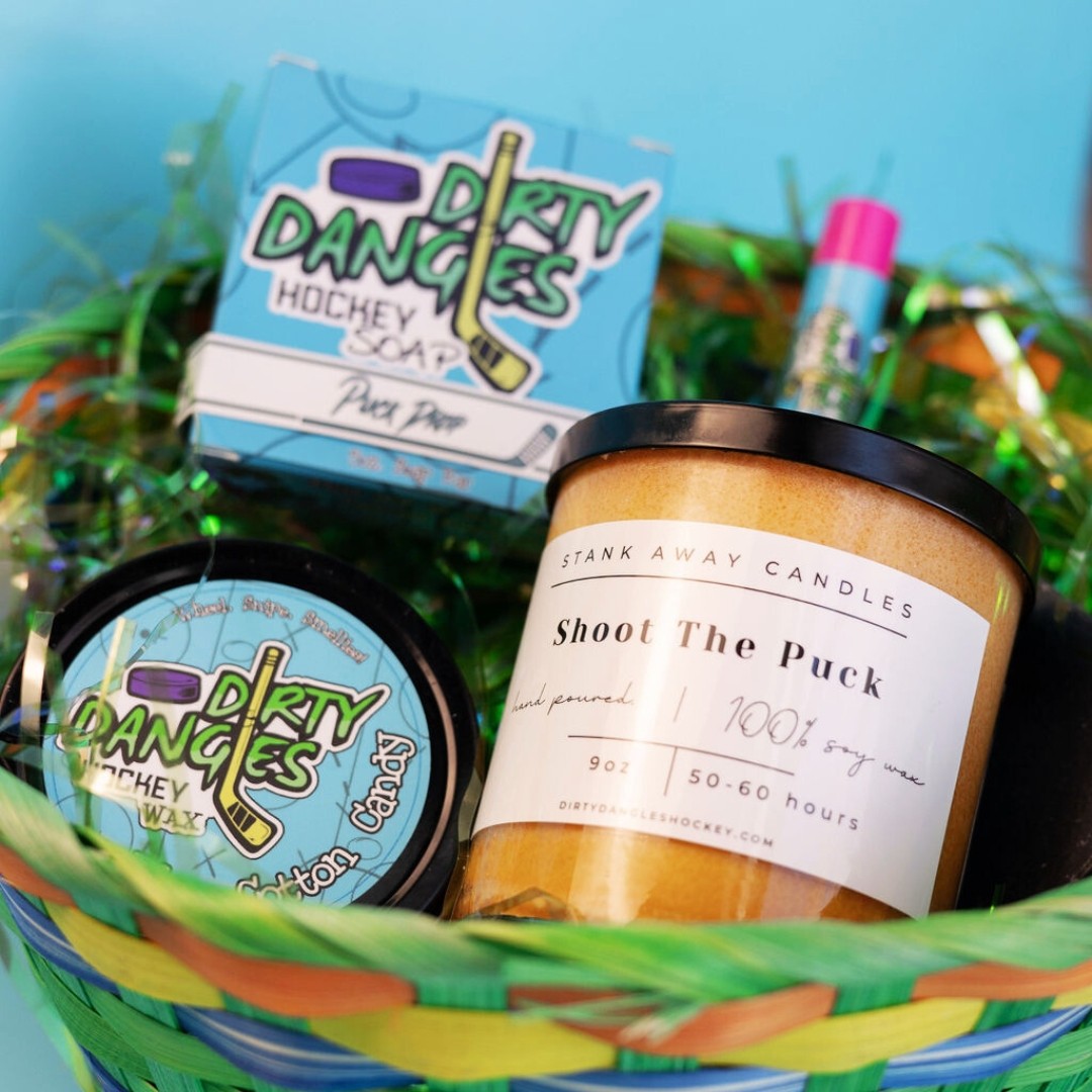 An easter basket full of dirty dangles hockey soap, lip balm wax and a candle