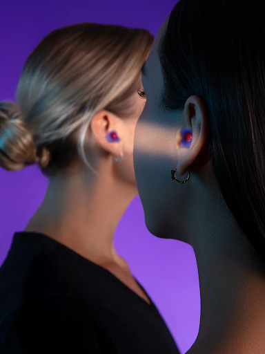 Two women side-view, wearing earplugs for napping to burn calories.