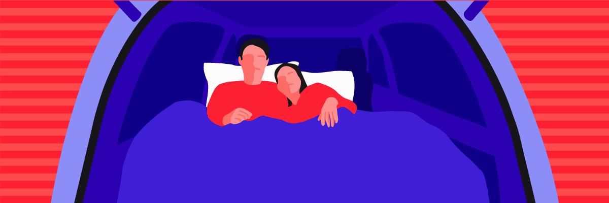 Two people lying on an air mattress in the back of an SUV demonstrating how to sleep comfortably in the back seat of a car.