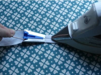 Ironing Bias Tape Binding as it comees out of the Bias Tape Maker