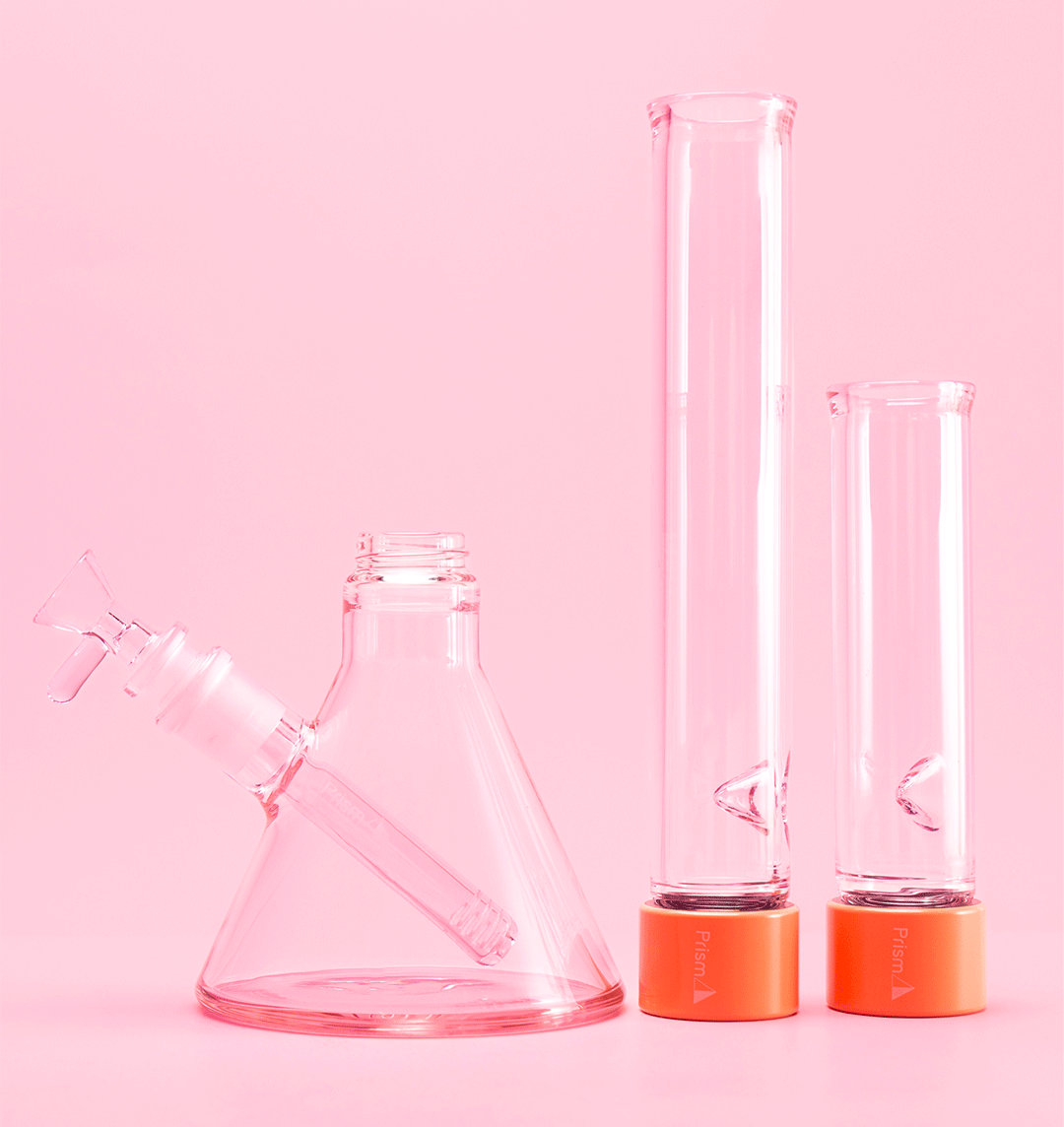 Disassembled Prism MINI Monochrome Pink Lemonade Beaker Bong showing all components, including standard and tall mouthpieces with ice pinches, highlighting its modular design.