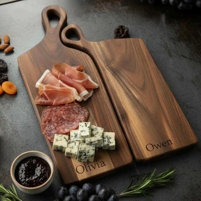 Personalized nesting charcuterie boards with custom engraved names on each.