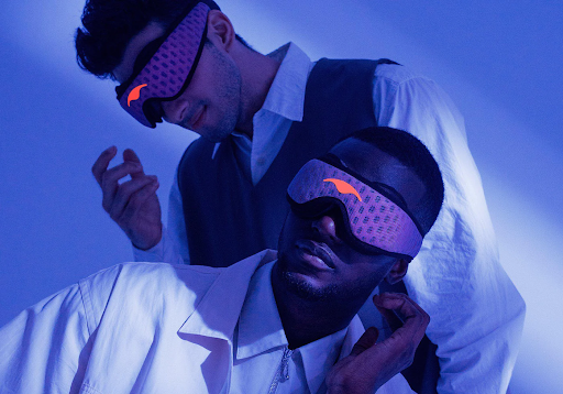 Two men wearing blue mesh adjustable sleep masks for side sleeping.