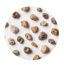 A bunch of brown colored frankincense kept over a white color background