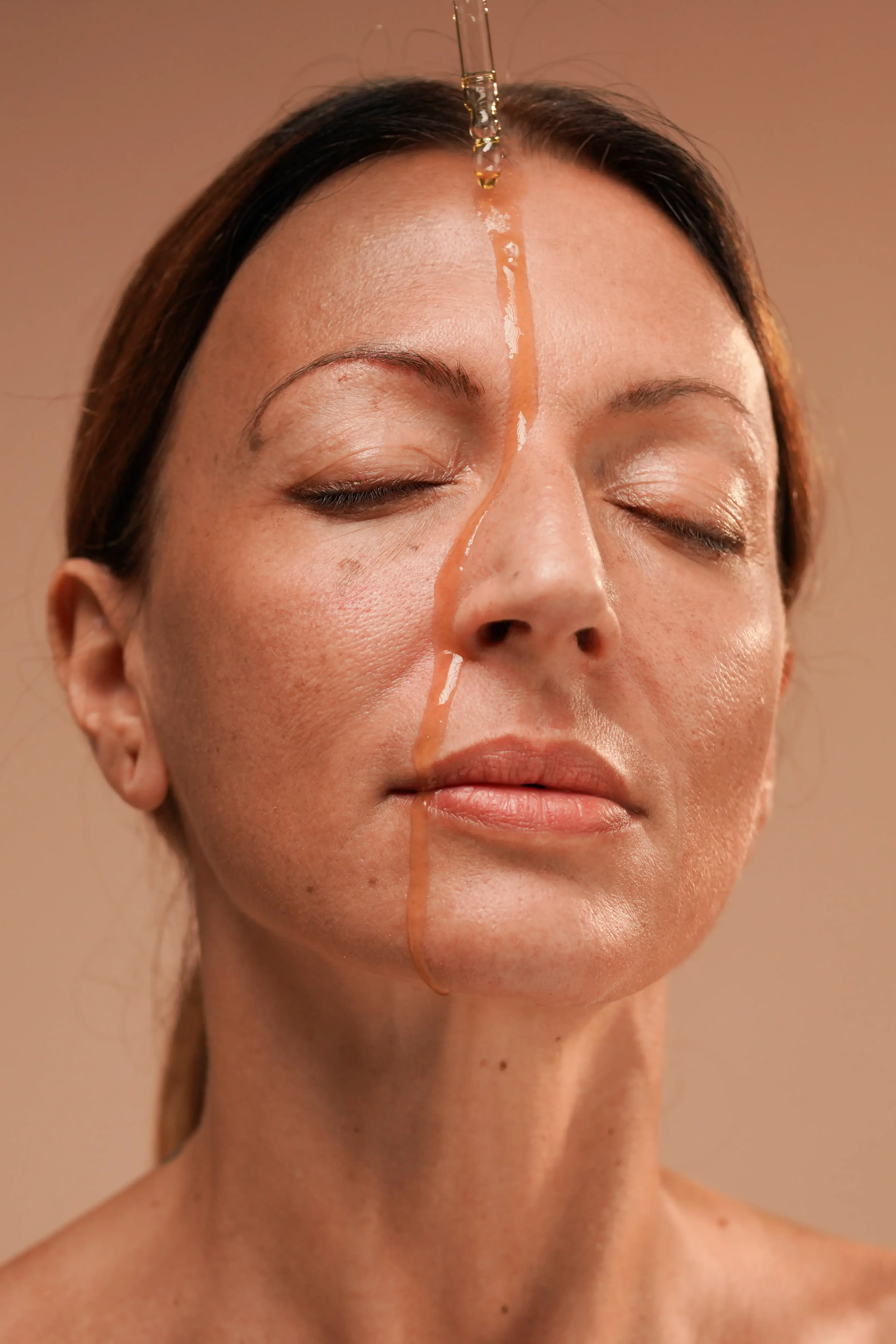 oil dripping down woman's face