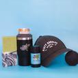 2 bars of hockey soap, a tactical green 2 in 1 drink tumbler can holder, a stick of dirty dangles natural deodorant and a dirty dangles hockey co. hat on a blue background.