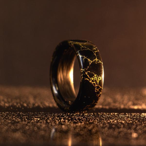 The Carbon Fiber Heretic is a and handmade ring crafted on gold veined TruStone and Carbon Fiber