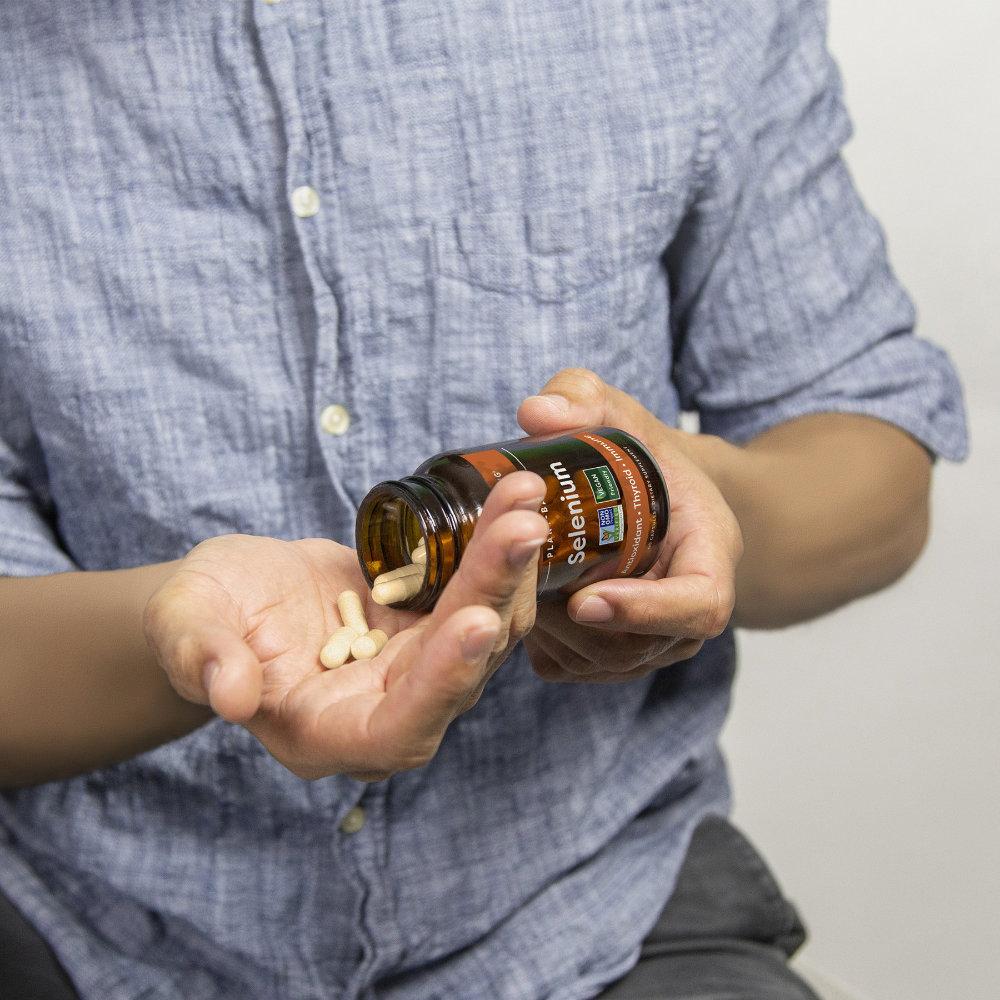 Global Healing Selenium Bottle In Hand