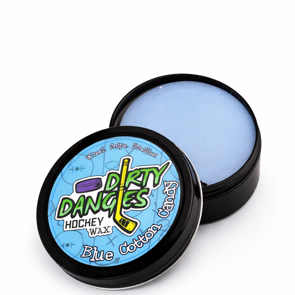 A tin of Dirty Dangles Hockey Stick Wax Blue Cotton Candy Scent sits open on a blue background surrounded by blue cotton candy.