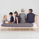 PeapodMats - washable bed mats for all ages. Family sitting on the bed protected with large grey PeapodMat.
