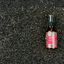 A bottle of Yauvari amplified youth spring kept over a layer of black gram.
