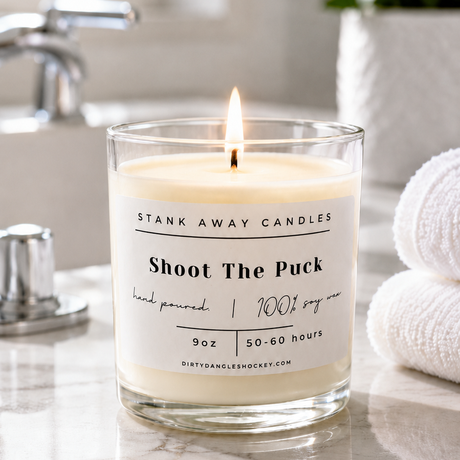 A white scented hockey candle in a bathroom. Shoot the puck