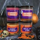 4 stank away halloween candles on a spooky halloween background. Spooky dookie, bathroom exorcism, silent but deadly and witch, you stink