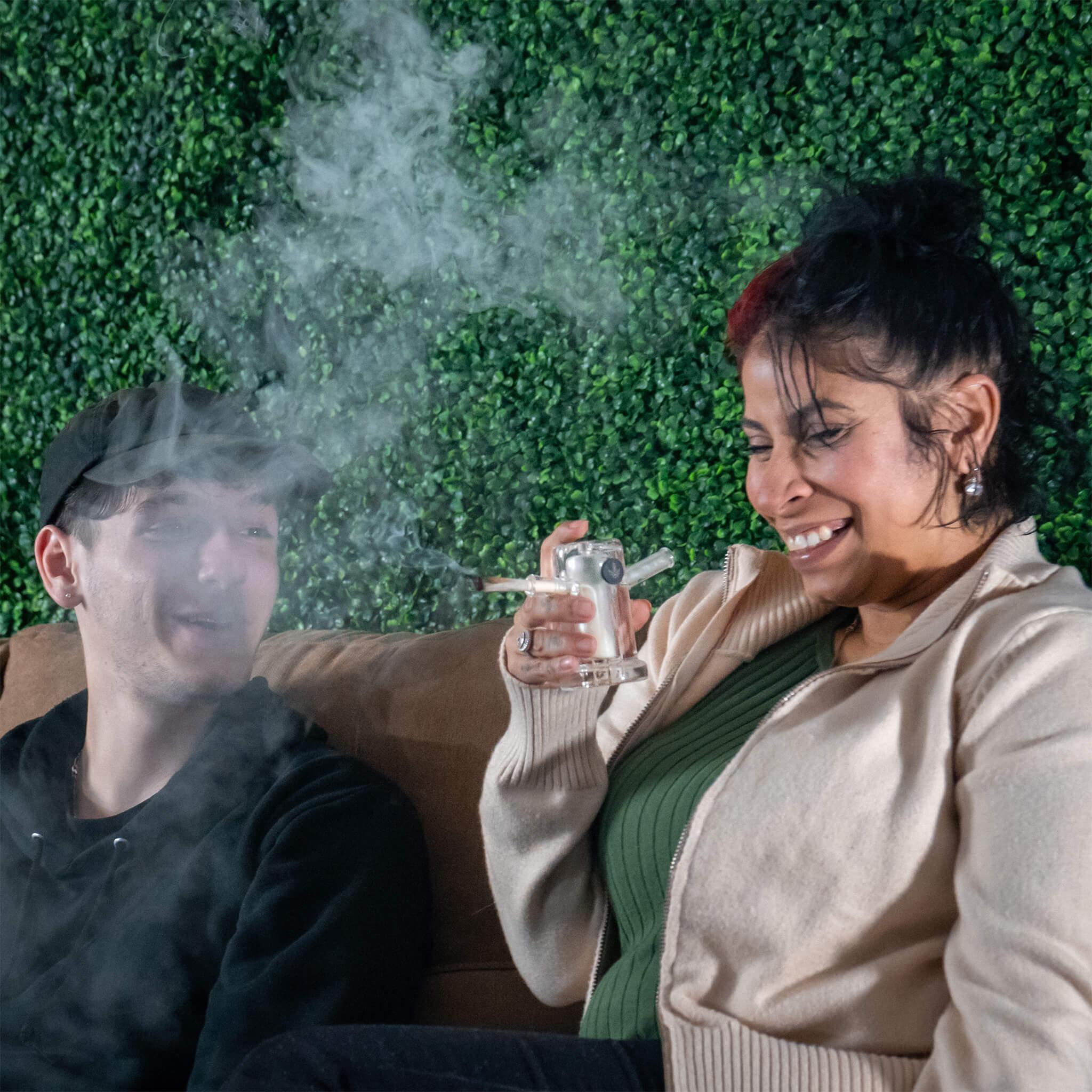 two people enjoying cannabis smoking