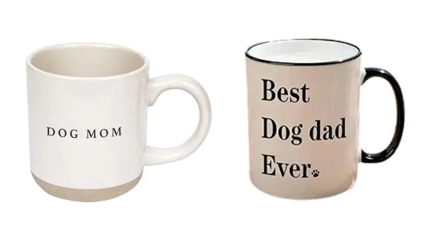 Two coffee mugs labeled "Dog Mom" and "Best Dad Ever" sit side by side on a wooden table.