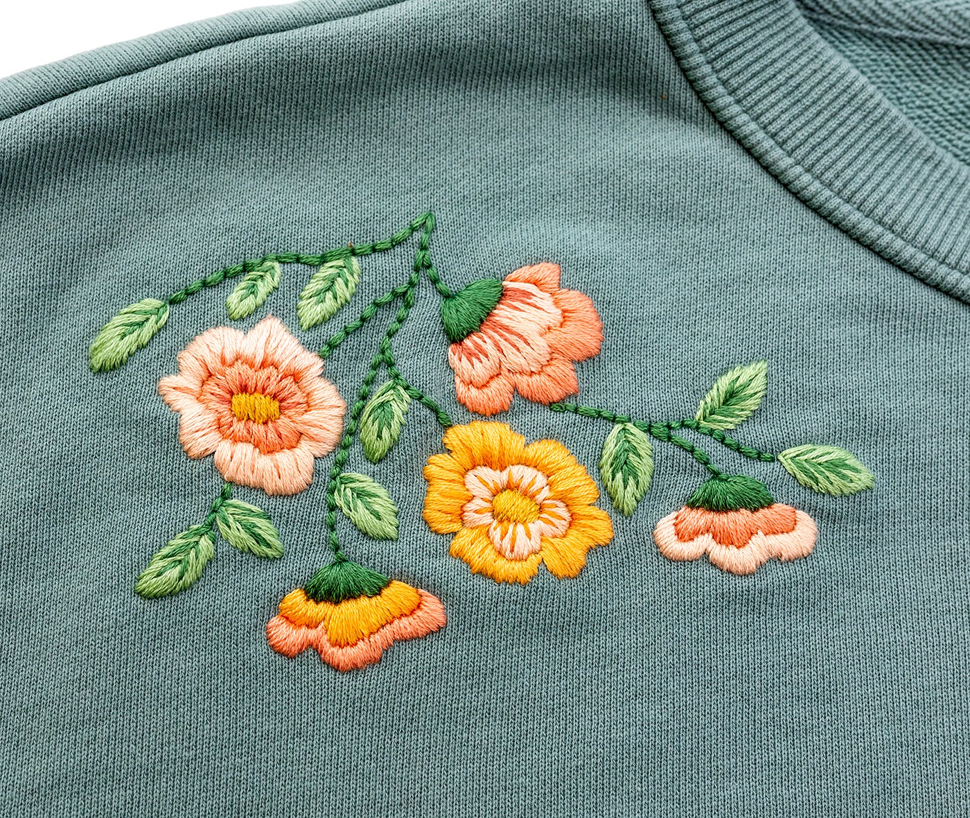 A floral design is stitched on fabric.