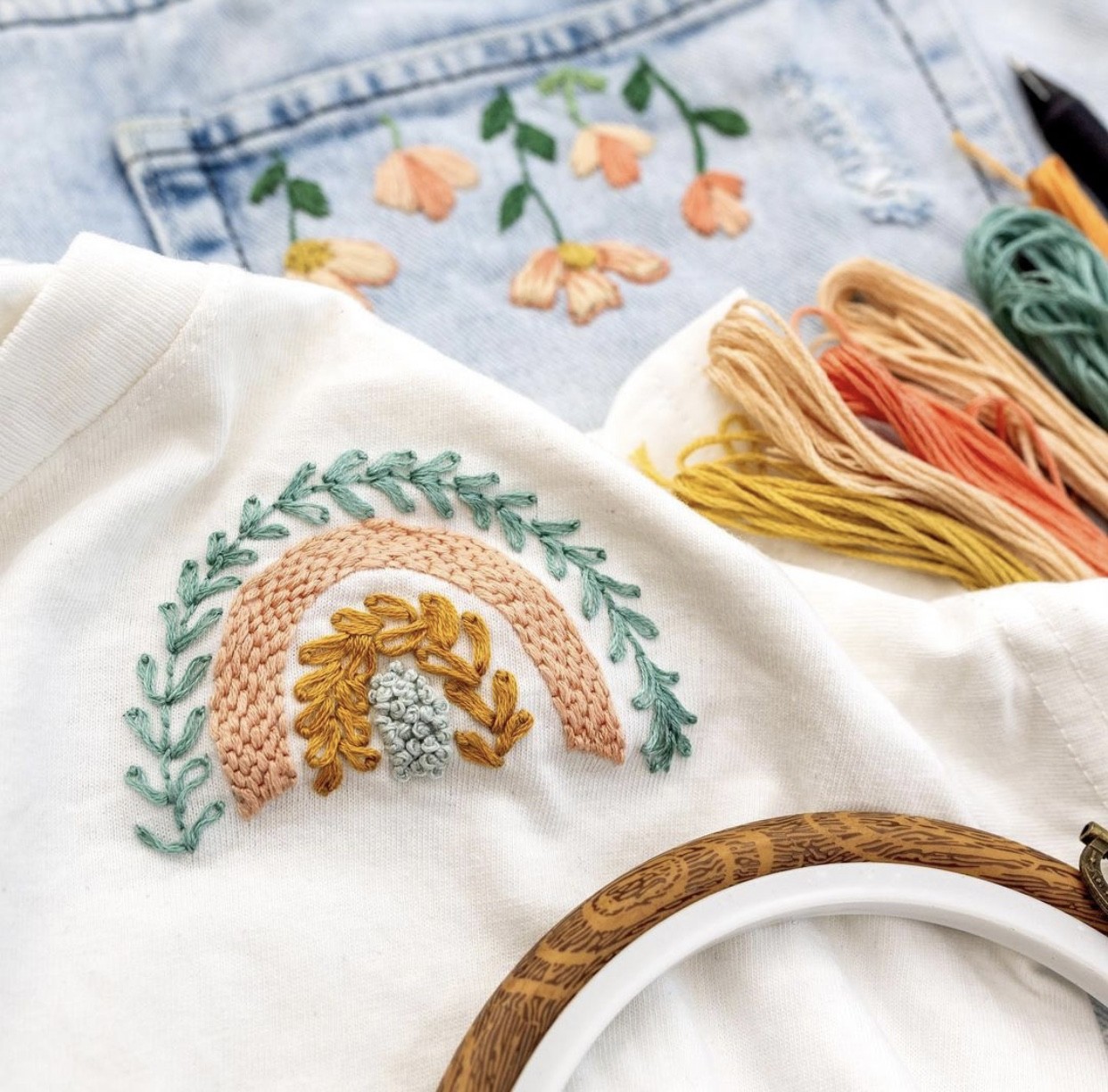 This image shows modern embroidery designs embroidered onto denim shorts and a white cotton shirt.