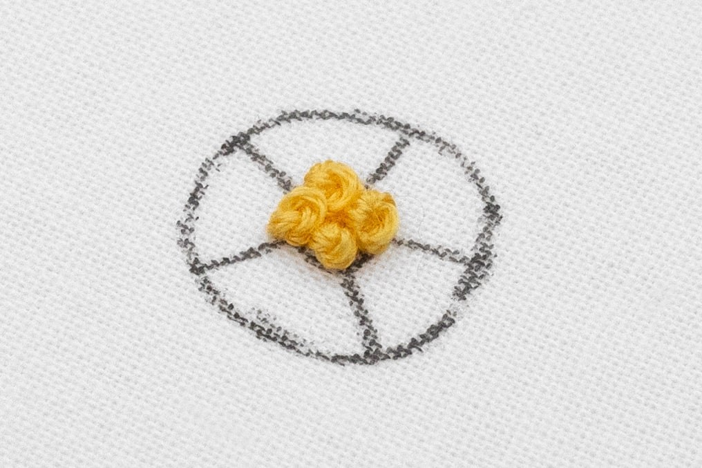 French Knots are clustered in the middle of the Woven Rose.