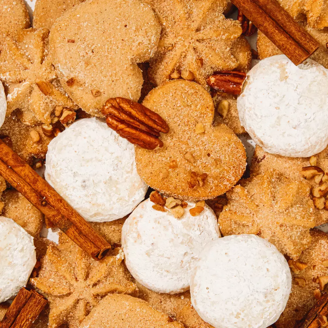 white and brown small cookies with pecans and cinnamon sticks