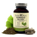 Dark amber glass bottle of Herbal Roots Ginkgo Biloba with green ginkgo leaves, ginkgo capsules and loose powder surrounding the bottle.