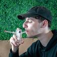 man smoking joint bubbler