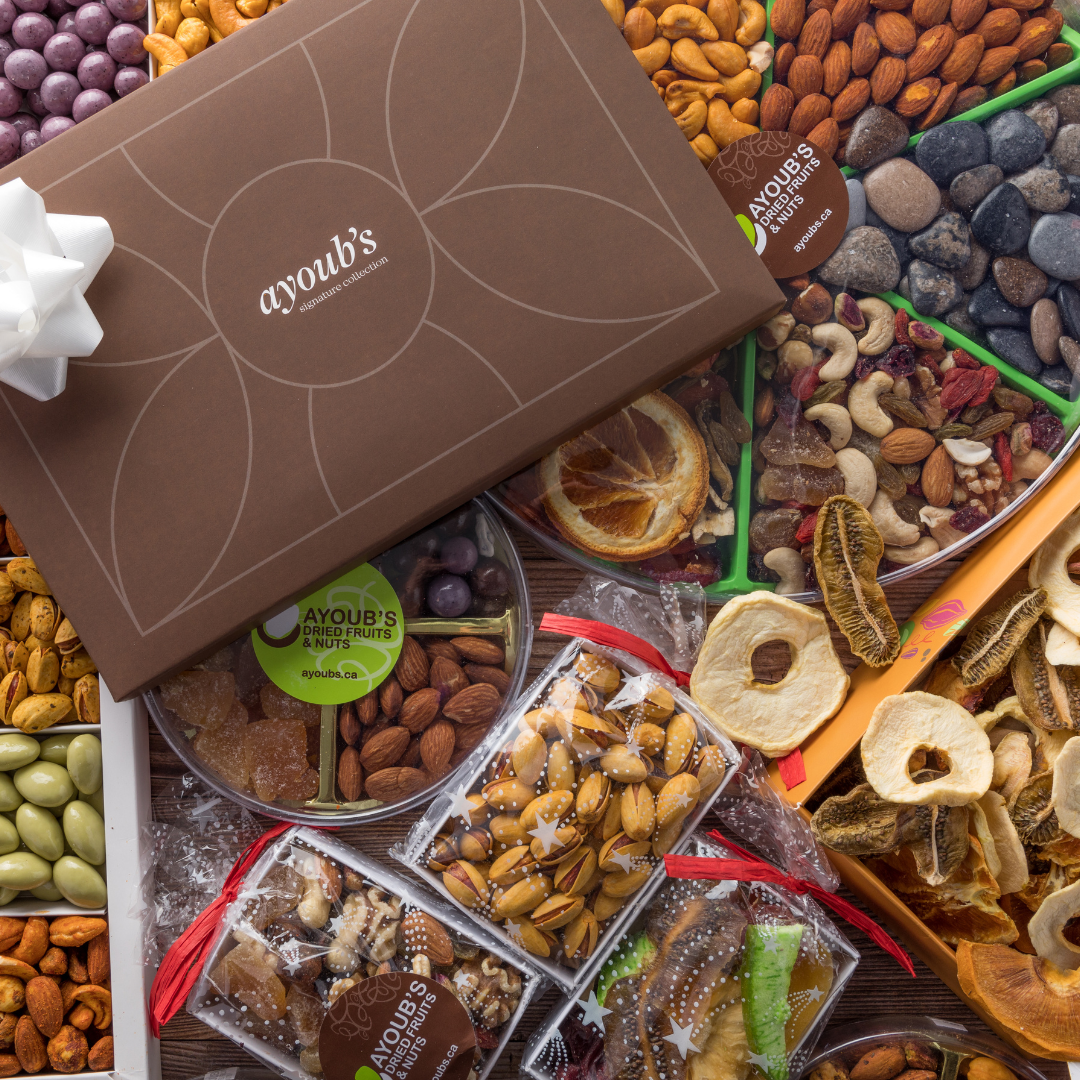 A beautifully presented gift box featuring a variety of nuts and dried fruits, surrounded by a vibrant selection of dried snacks, perfect for gifting.