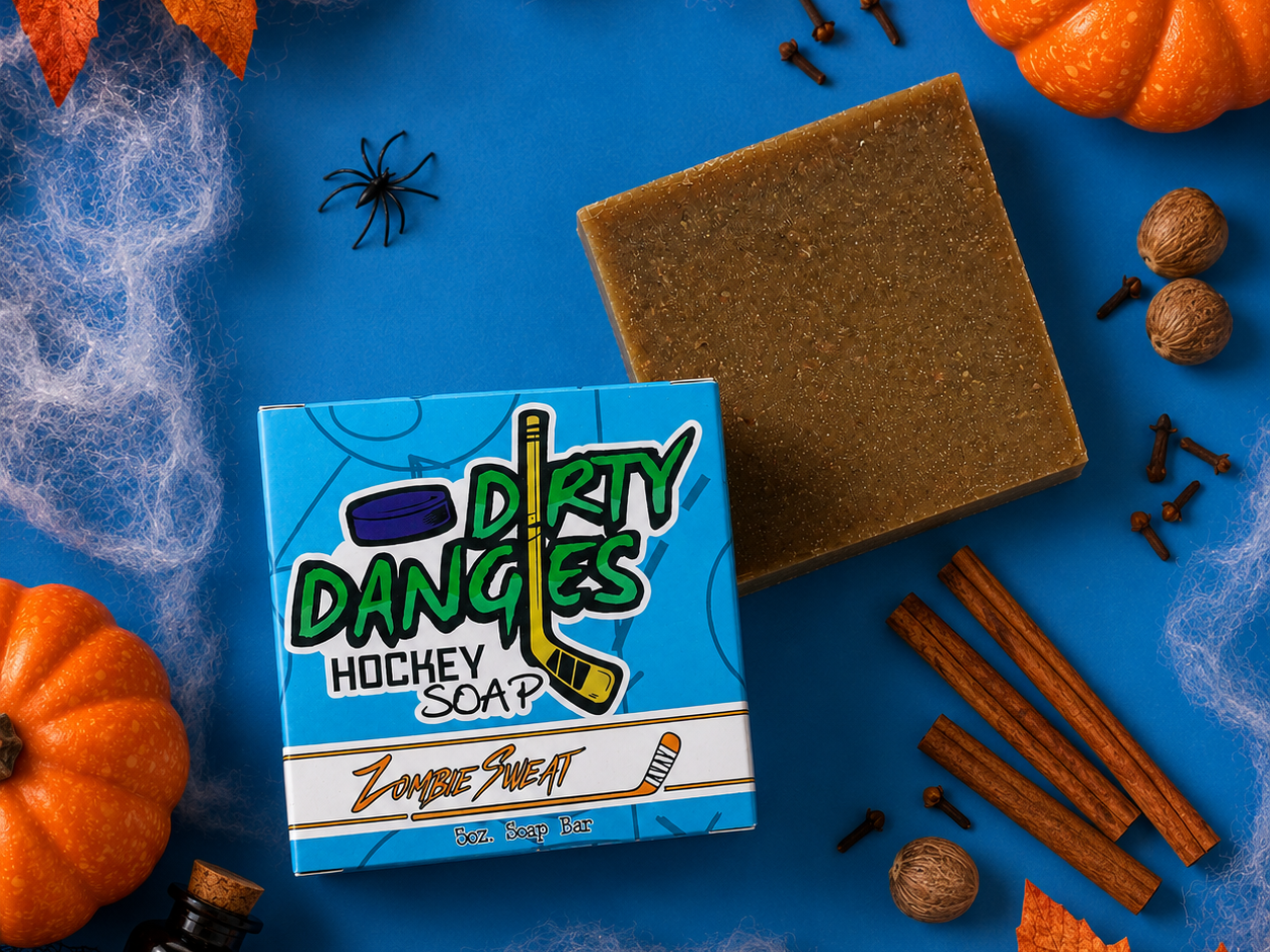 zombie sweat pumpkin spice scented hockey soap bar on a blue background with spices, spiderwebs and fall decor