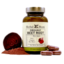 Close up of a bottle of Herbal Roots Organic Beet Root supplement with a few capsules to the front right of the bottle and a small pile of beet root powder with a slice of raw beet root to the left of the bottle