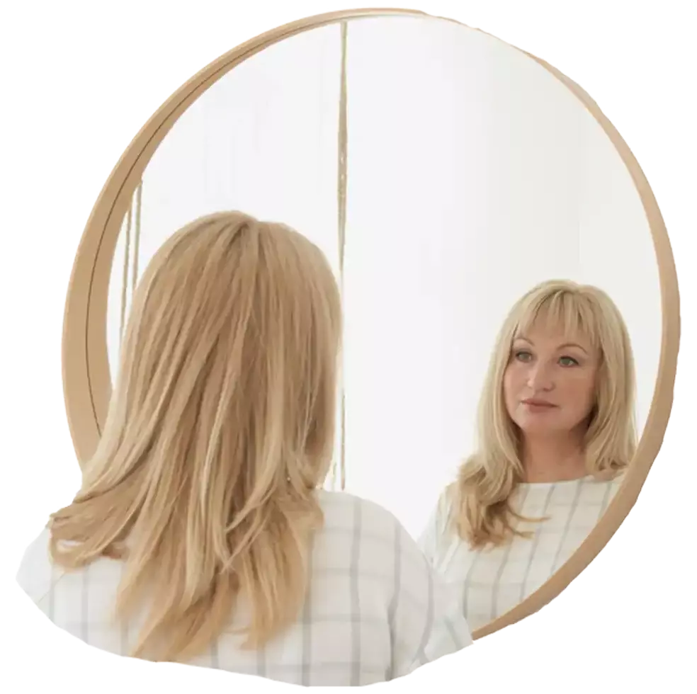 Woman looking into a mirror