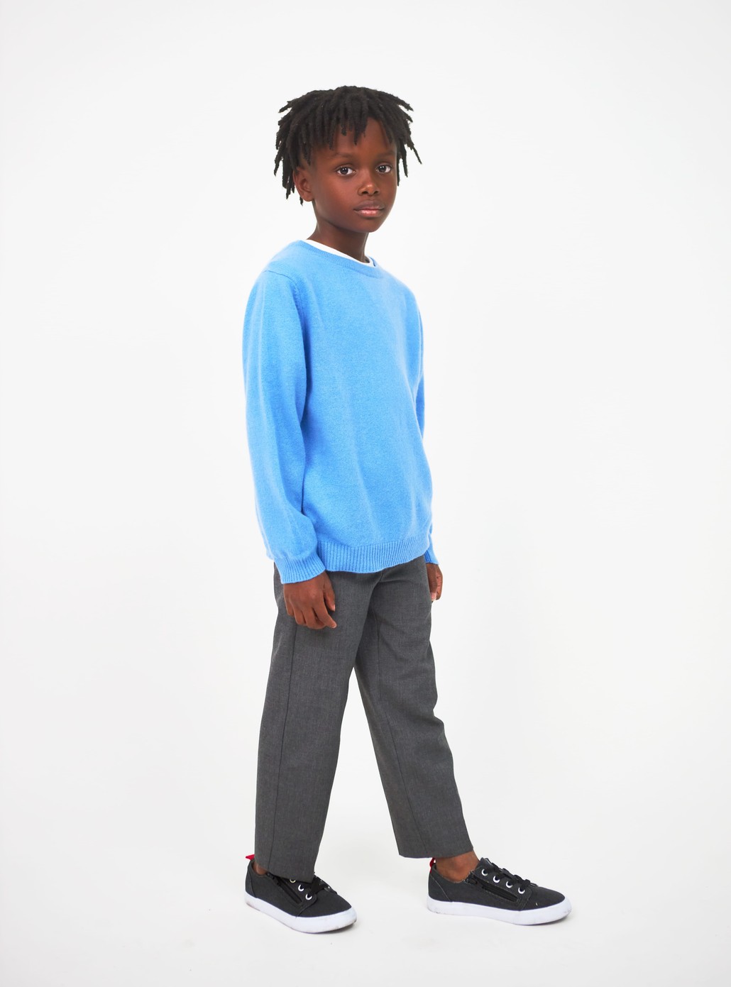 Boy wearing light blue cashmere sweater and gray pants