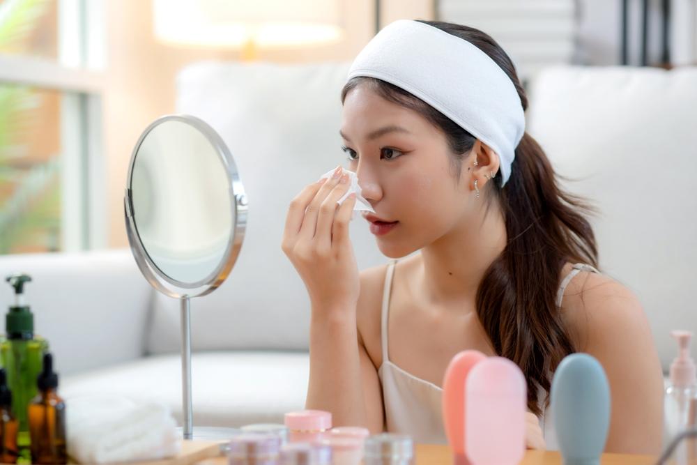Woman applying niacinamide as the third step in her skincare routine.